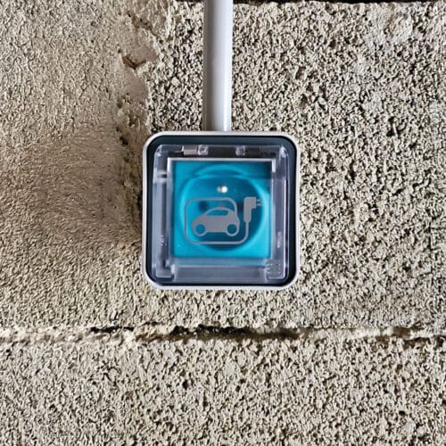 Prise Green'Up sur un mur en parpaings.
